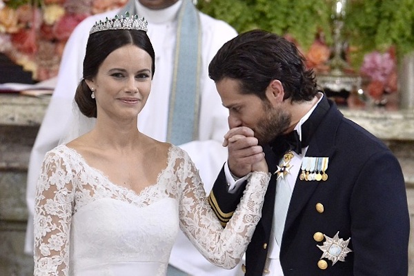 Sweden's Prince Carl Philip (R) kisses Sofia Hellqvist's hand during their wedding ceremony at the Royal Chapel in Stockholm Palace on June 13
