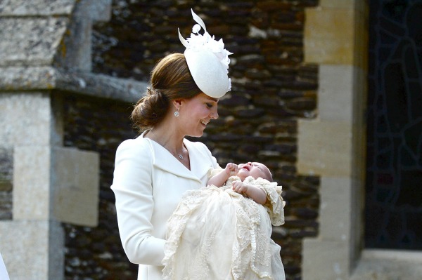 Norfolk, England, July 5th: The Duchess of Cambridge carries her daughter Princess Charlotte into the Church of St Mary Magdalene on the Sandringham Estate for the princess's christening, on July 5th 2015. The Duchess and her daughter were accompanied by the Duke of Cambridge, their son Prince George, the Queen, Prince Philip, the Middleton family and the princess' five godparents, Laura Fellowes, Adam Middleton, Thomas van Straubenzenee, Sophie Carter and James Meade. Photograph by Mary Turner/The Times/Pool