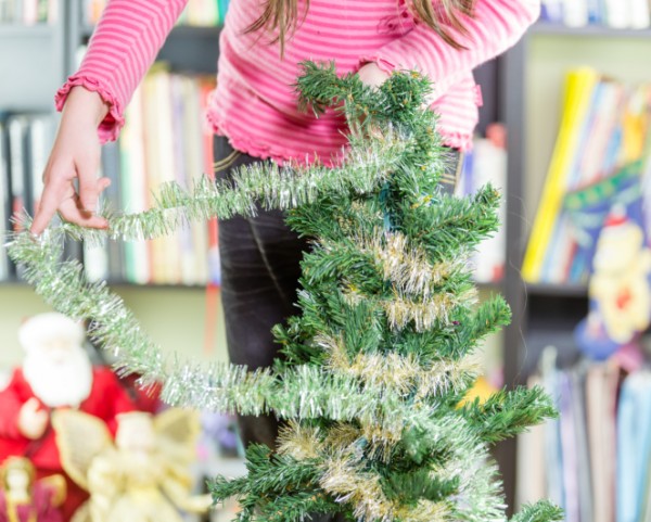 Little girl decorating Christmas tree