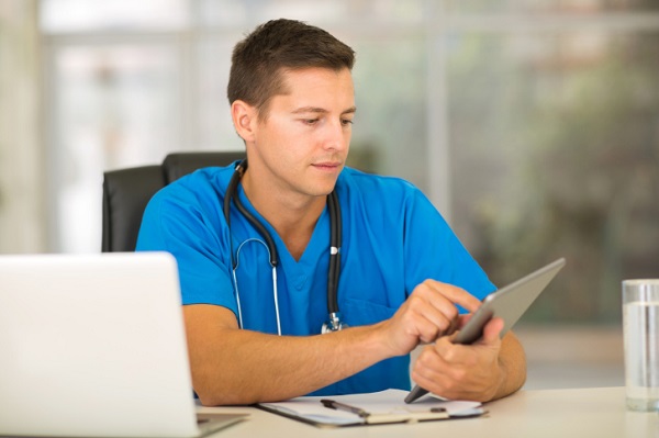 male medical intern using tablet computer