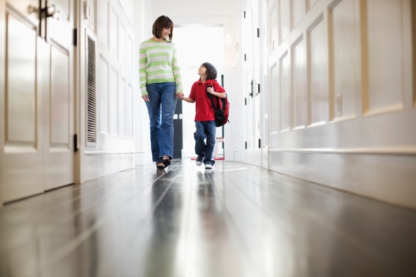 Mother and Son Walking in Hallway